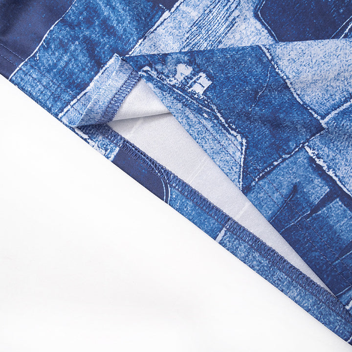 Product detail of the halter neckline, blue print and fitted waist on the sleeveless dress.