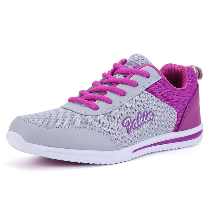 Gray and purple lace-up shoe in three-quarter view on white, showing purple laces, gray mesh upper, heel loop and white sole.