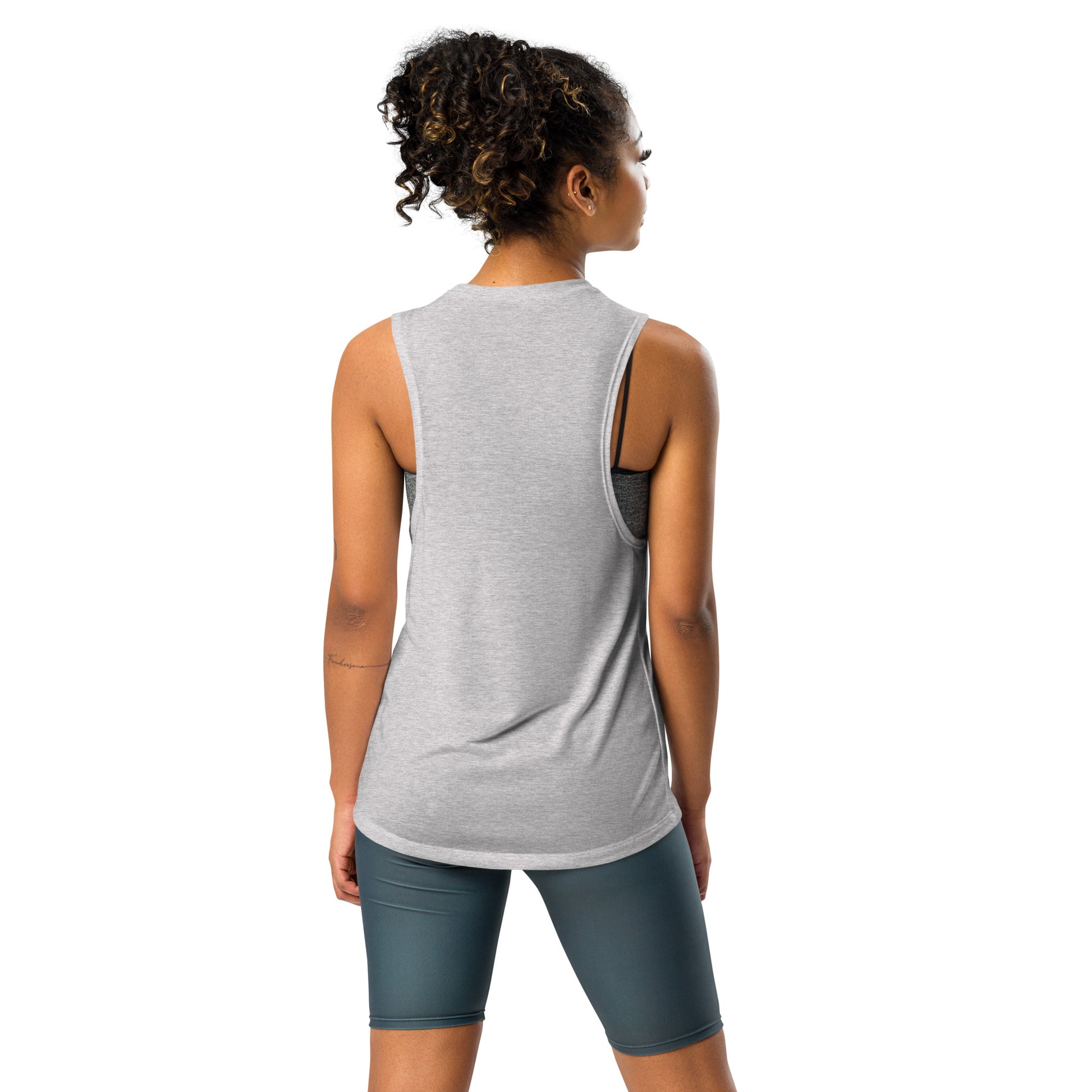 Back view of ladies’ muscle tank, dropped armhole reveals bold bra color pop and sculpted shoulders.

