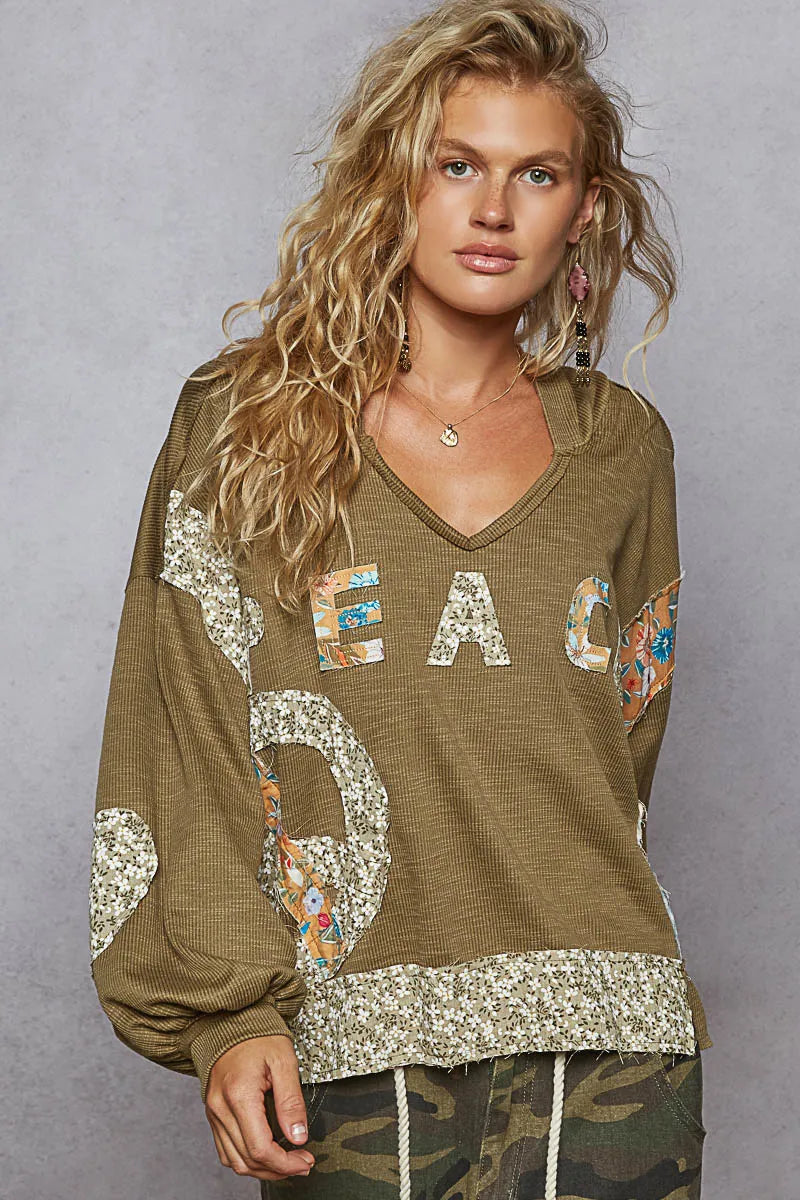 Flat-lay of hoodie showing sparkly details and stitching

