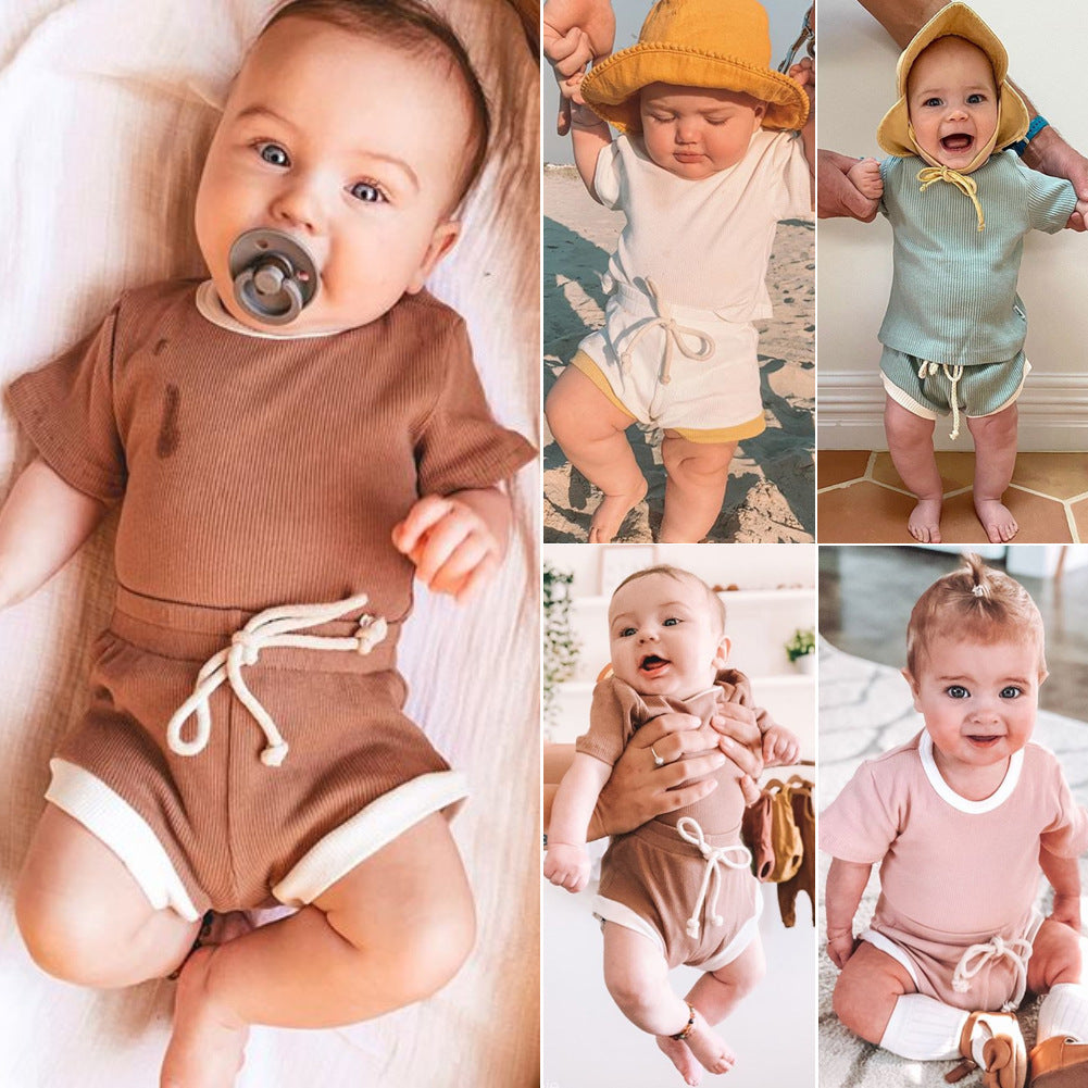 Close-up of non-hooded infant two-piece set featuring diagonal single-breasted closure.