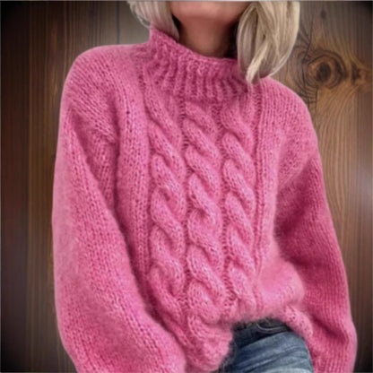 Elegant women's turtleneck sweater in peach, styled with jeans for casual winter look.