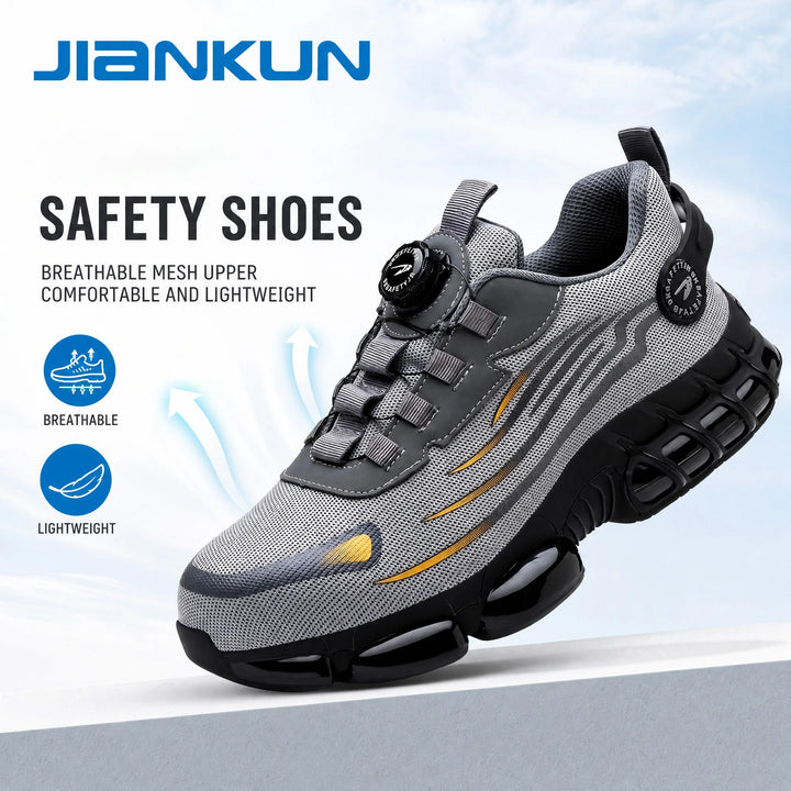 Grey mesh steel toe safety shoe with dial-style fastening and a black segmented sole.