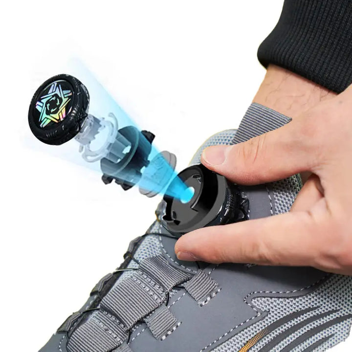 Close-up of the dial-style cable fastening on a grey athletic steel toe shoe.