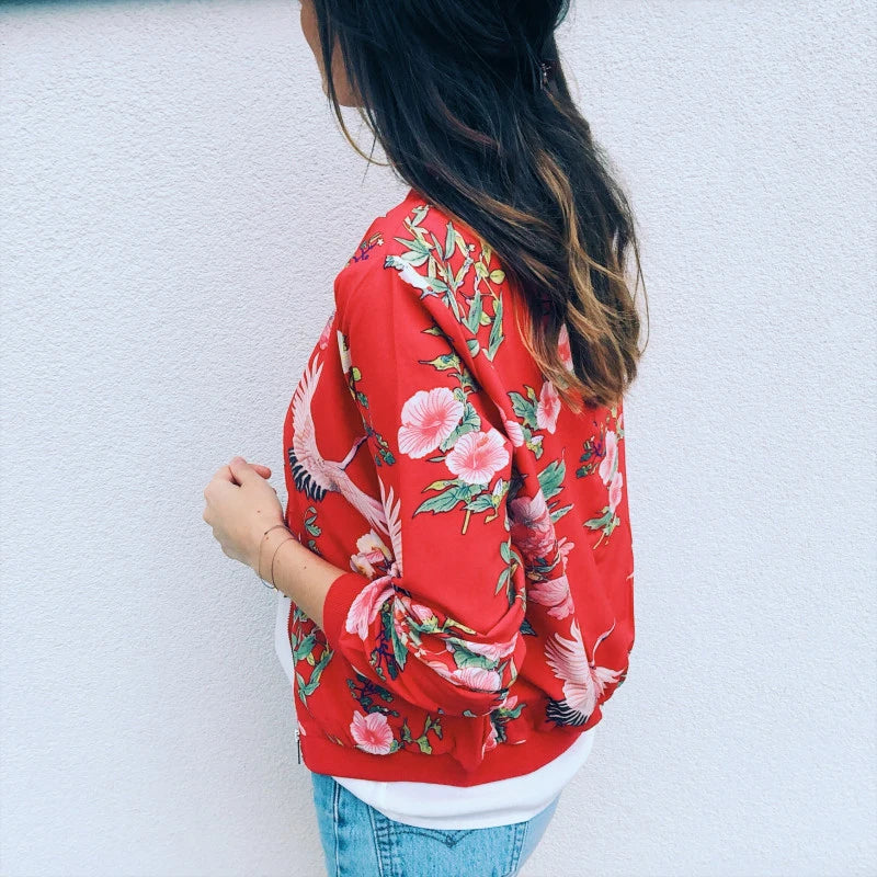 Back view of the Red floral jacket on the model, showing large white and pink blossoms, green foliage and the red ribbed hem.