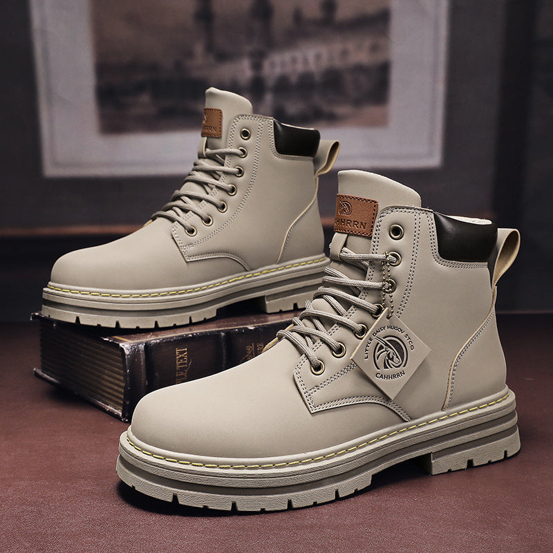 Flat lay of men's boots in gray with laces, sole tread, and clean stitched finish
