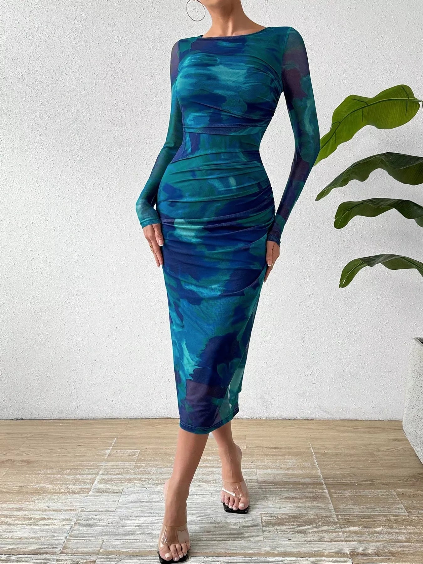 Model twirling in the Watercolor Print Mesh Bodycon Midi Dress—capturing fluid movement and watercolor-inspired hues.
