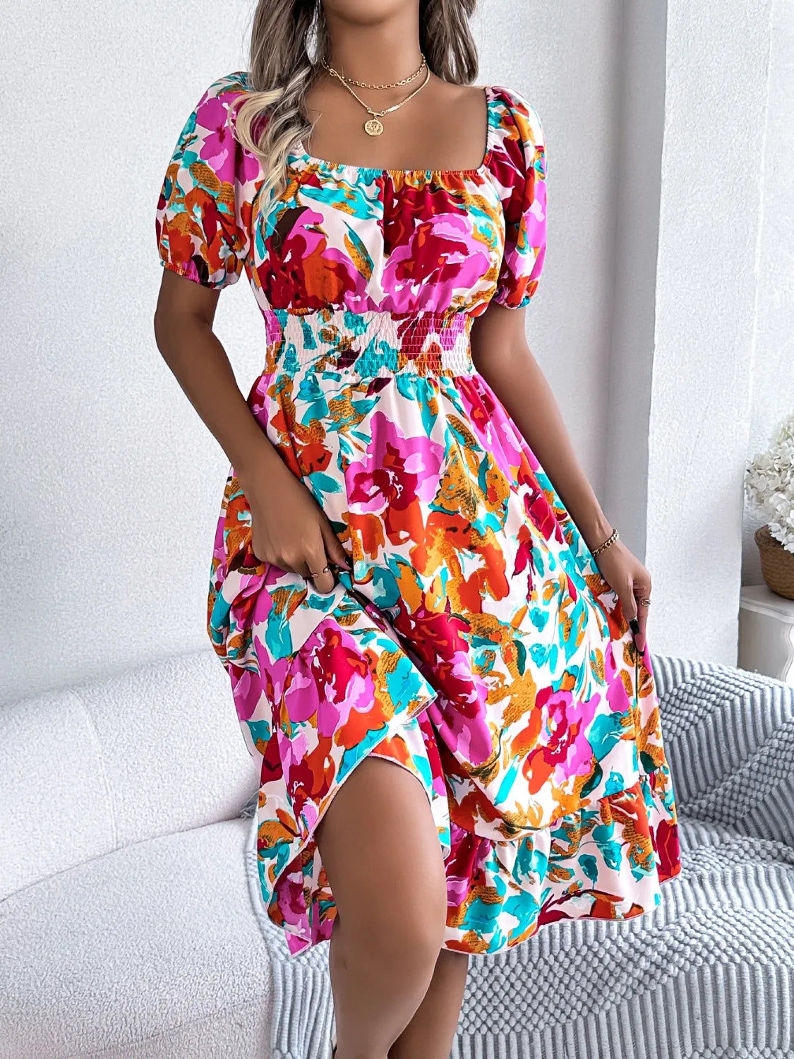 Model twirls in floral ruffle hem midi dress under sunshine

