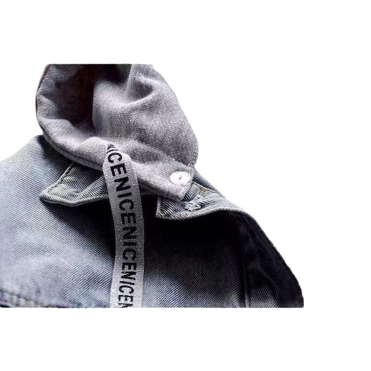 Close view of the grey hood and printed drawstring beside the washed blue denim collar, with metal snap and visible stitching