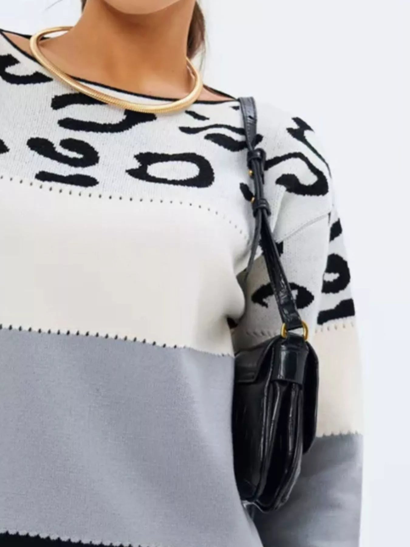 Plus size model in animal print sweater side angle