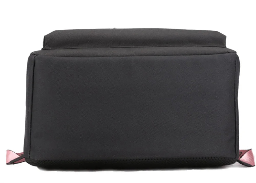 Bottom view of black reference school backpack, showing its rectangular fabric base, seams and black construction in a photo.