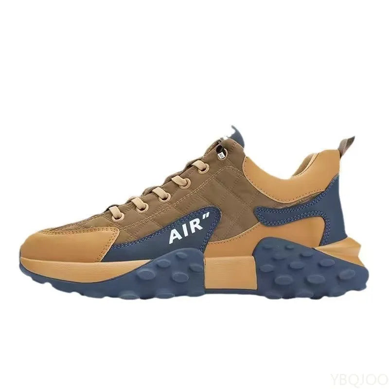 Brown and Navy lace-up sneaker shown in side profile on a plain backdrop, with tan collar and sculpted navy outsole sections.