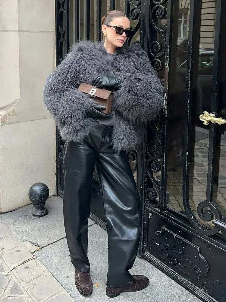 Cropped faux fur coat women look with O-neck collar and open front, white faux fur contrasts with black bag
