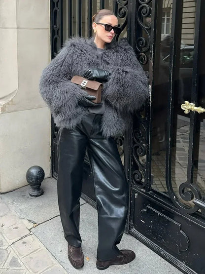 Cropped faux fur coat women look with O-neck collar and open front, white faux fur contrasts with black bag
