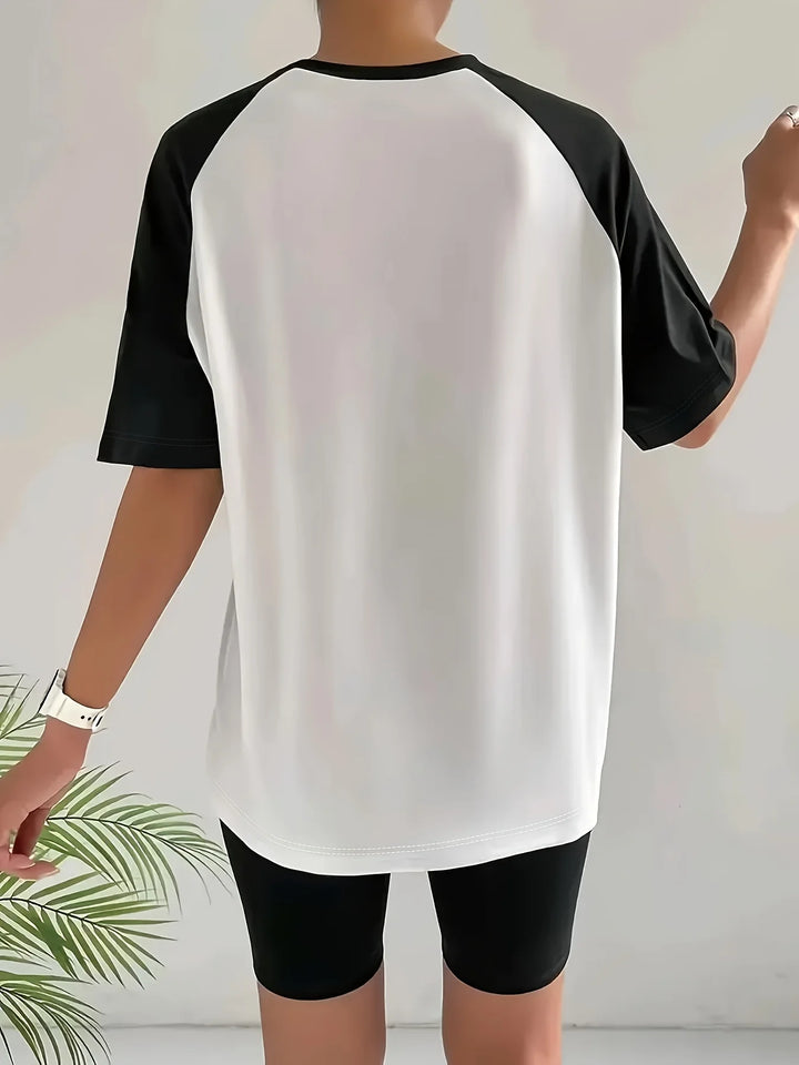 Original rear photo showing the plain white back and black raglan sleeves