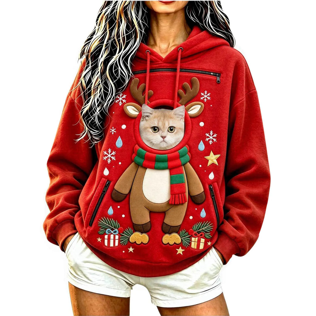 Model wearing a red reindeer hoodie with a cat at the circular front opening with a hood, long sleeves and black zip pockets.