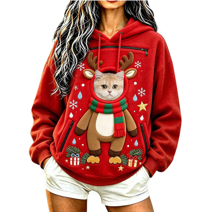 Model wearing a red reindeer hoodie with a cat at the circular front opening with a hood, long sleeves and black zip pockets.