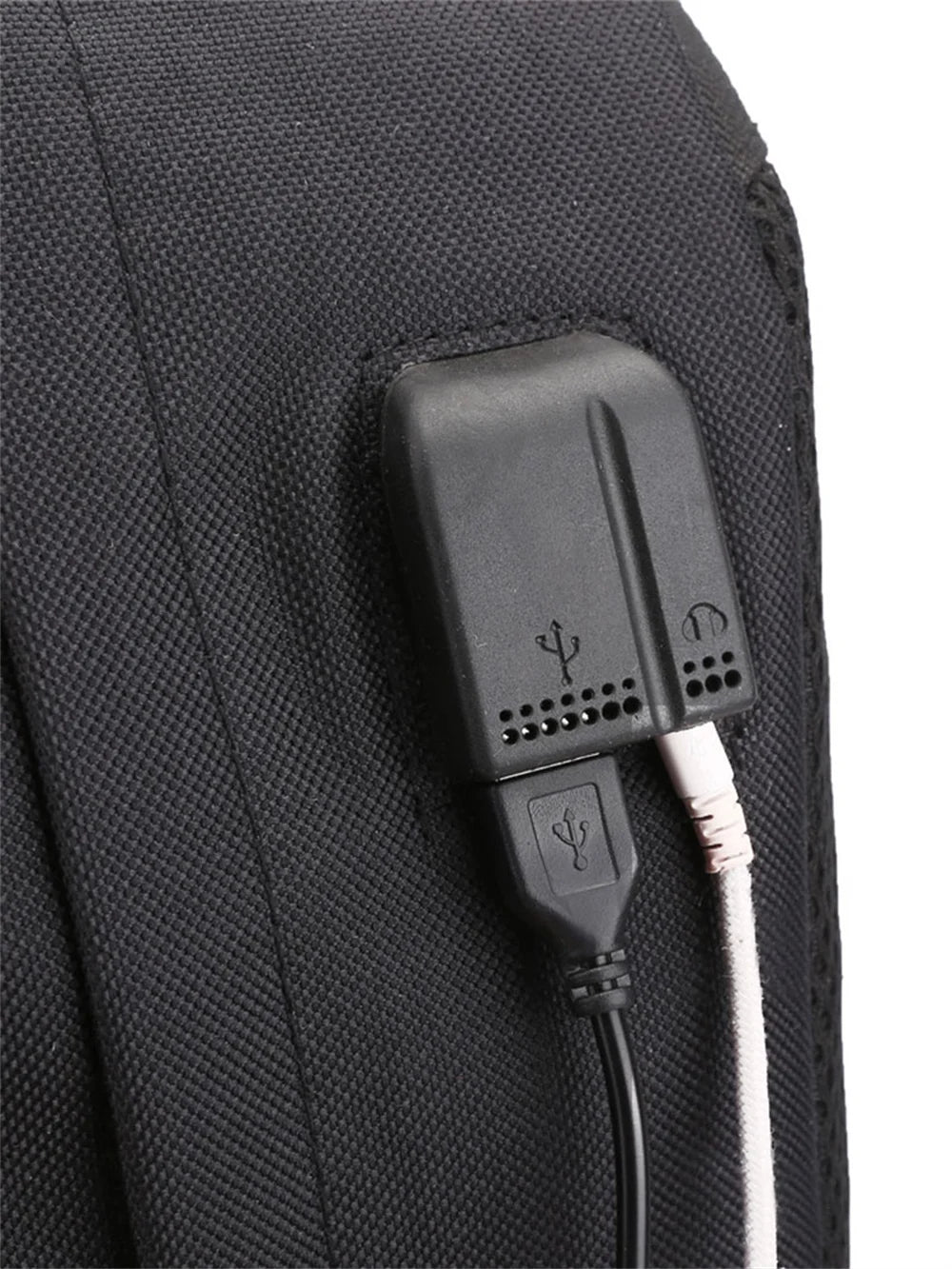 Close view of the side USB port with a connected white cable on the black bag in an original supplier construction reference.