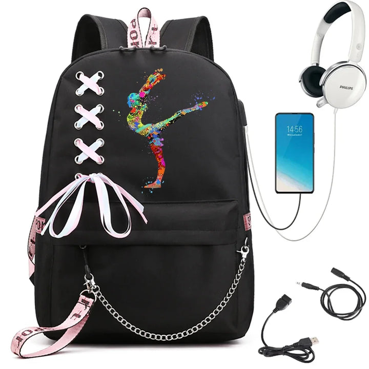 A black backpack featuring an extended gymnast print, pale ribbon lacing, pink accents and chain, beside demonstration props.