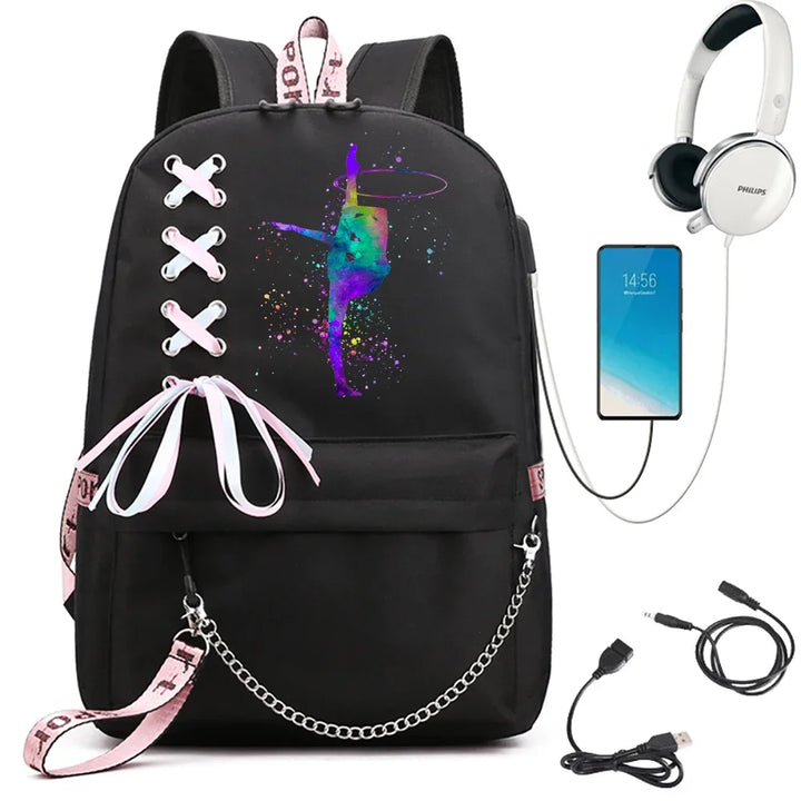 A black school backpack with a multicolor hoop gymnast print, ribbon lacing, pink trim and chain, beside demonstration props.