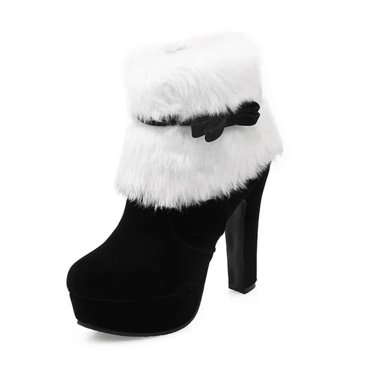 Black ankle boot on white background with a fluffy white cuff, a matching bow strap, round toe, platform and high block heel.