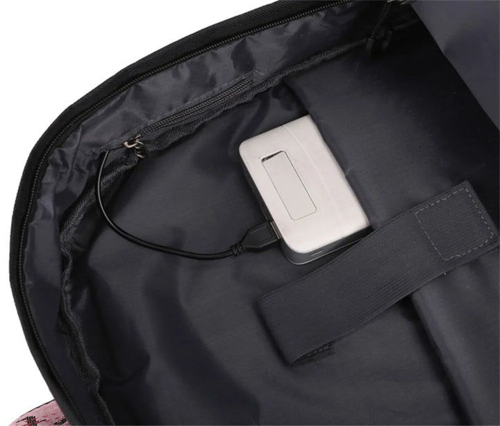 Interior connection cable in black reference school backpack, shown with an external power bank as a demonstration in detail.