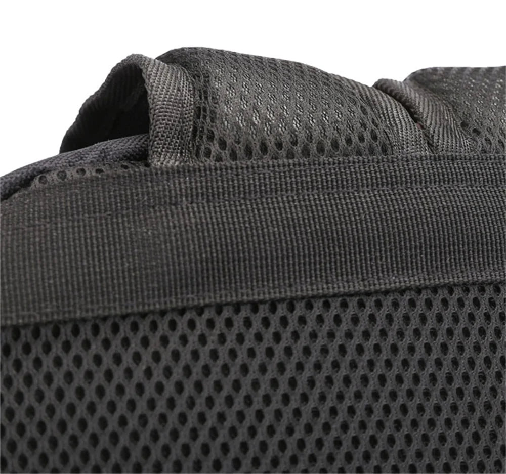 Close view of the top section of the mesh back panel, showing the black handle seam and stitching on the plain base backpack.