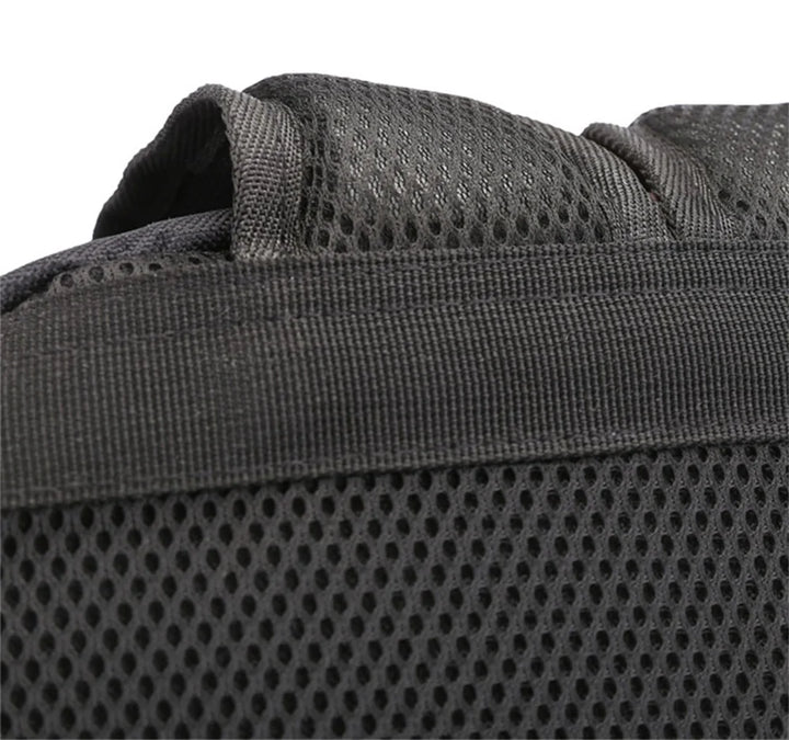 Close view of the top section of the mesh back panel, showing the black handle seam and stitching on the plain base backpack.