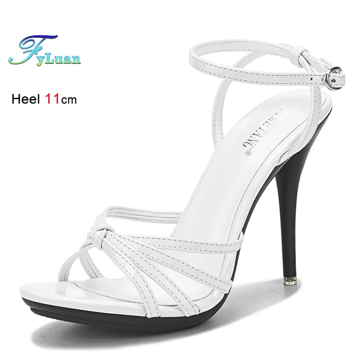 White high-heeled sandal with thin straps on a white background, featuring &