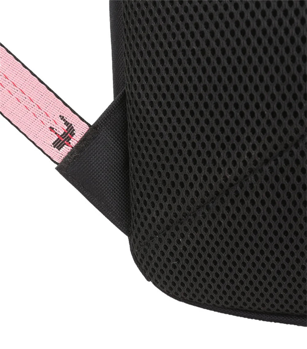 Close-up of black mesh back panel beside pink webbing, showing the visible surface texture of the school backpack in a photo.