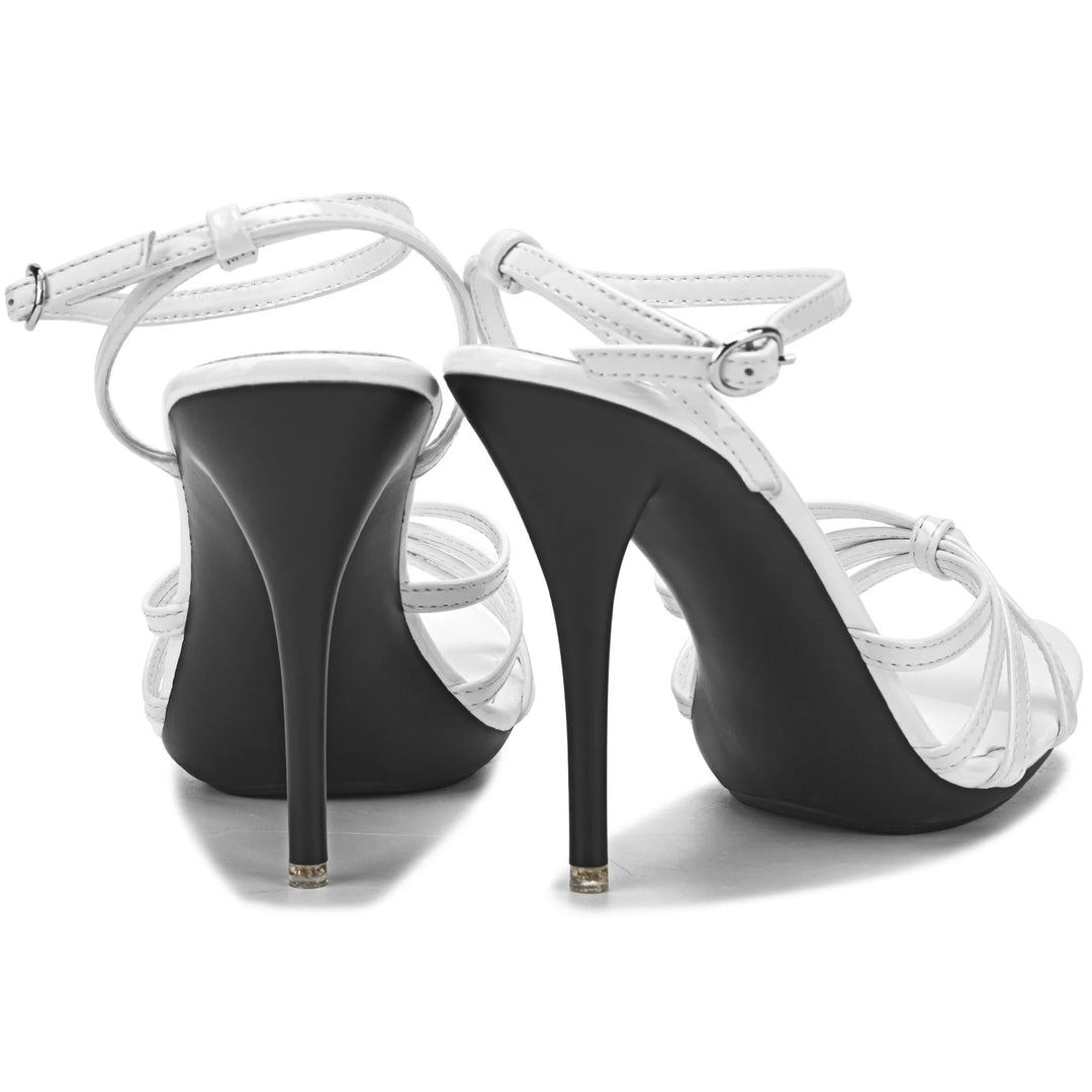 Black high-heeled shoes with white straps on a white background