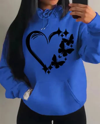 Model posing in apricot butterfly hoodie street style with baggy jeans look