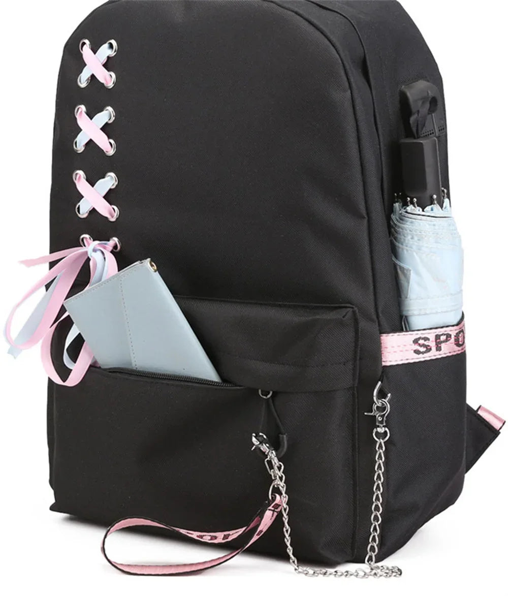 Three-quarter view of the base backpack with pink ribbon bow, front pocket and chain, plus a bottle and phone shown as props.