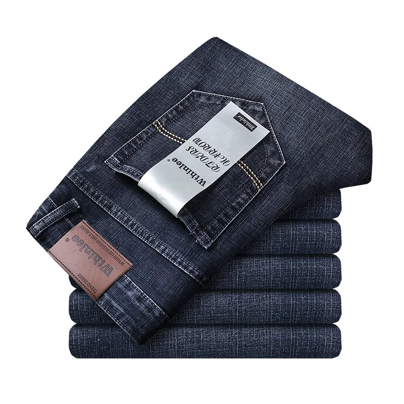 "smart casual men's jeans in deep indigo wash styled with knit sweater for modern business look"
