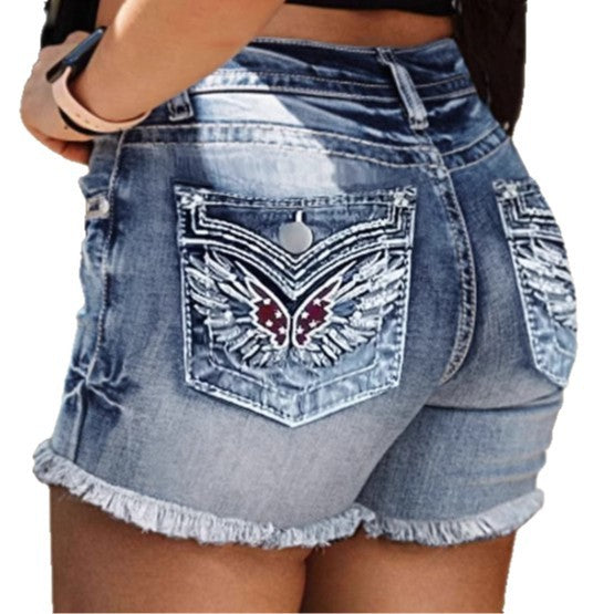 Stylish women’s denim shorts – washed blue with elegant embroidery design