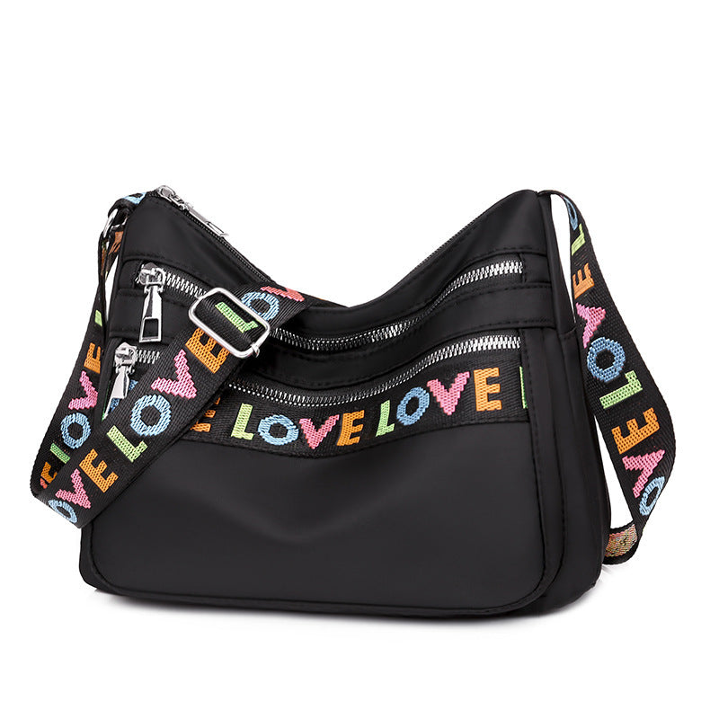 Timeless Black Oxford Cloth Crossbody Bag with Soft Fabric and Letter Embellishments