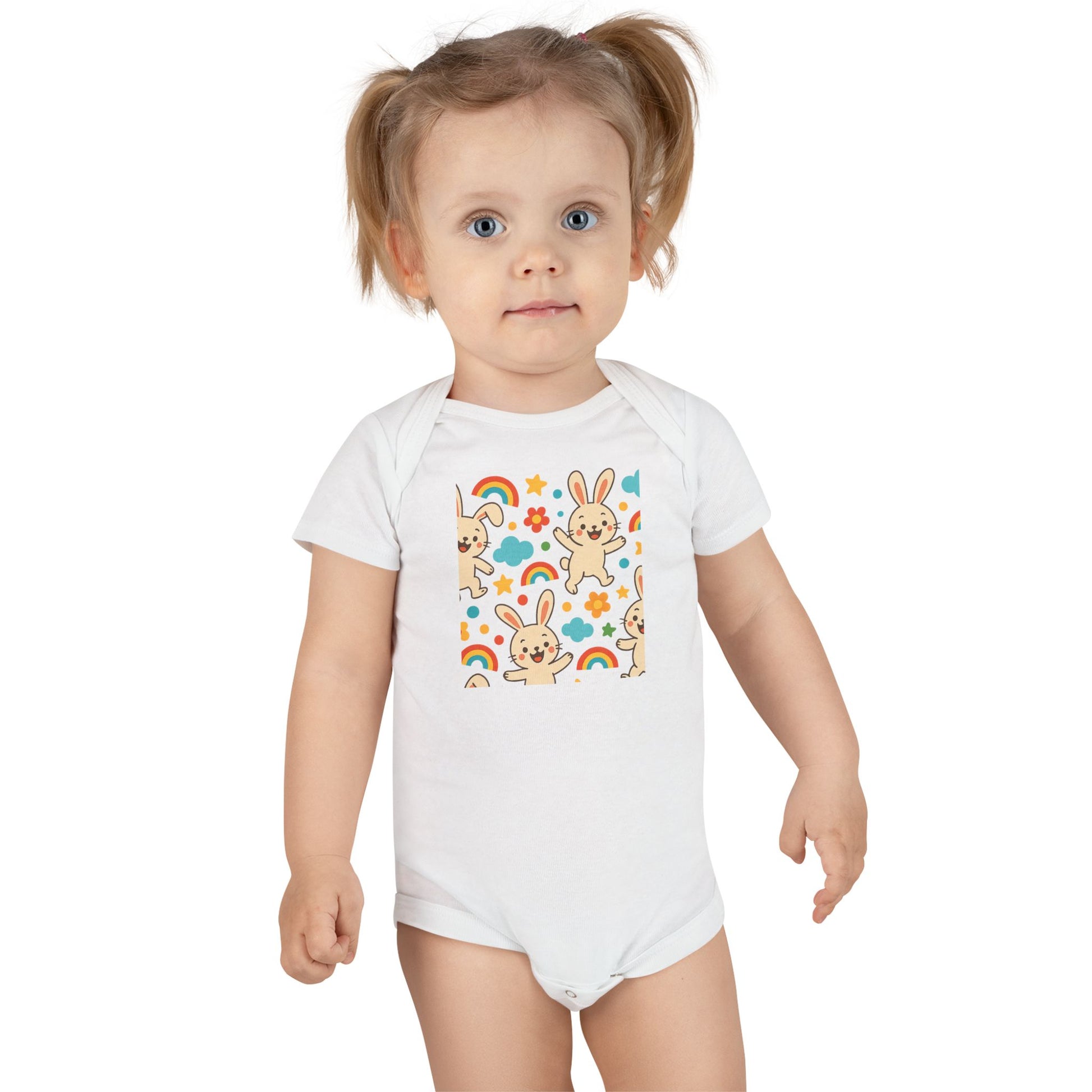 Close-up of cute bunny baby onesie print featuring cheerful bunnies and rainbows

