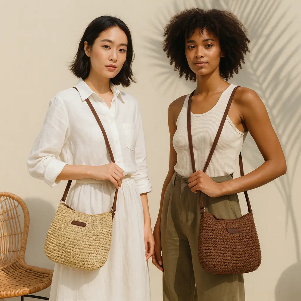 Two women holding woven handbags against a neutral background