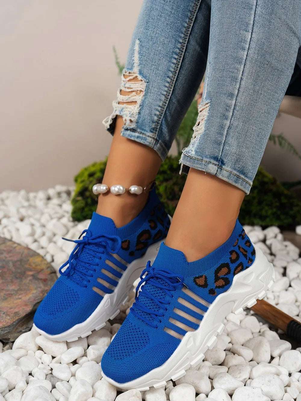 Detail of lace and mesh texture on leopard mesh sneakers

