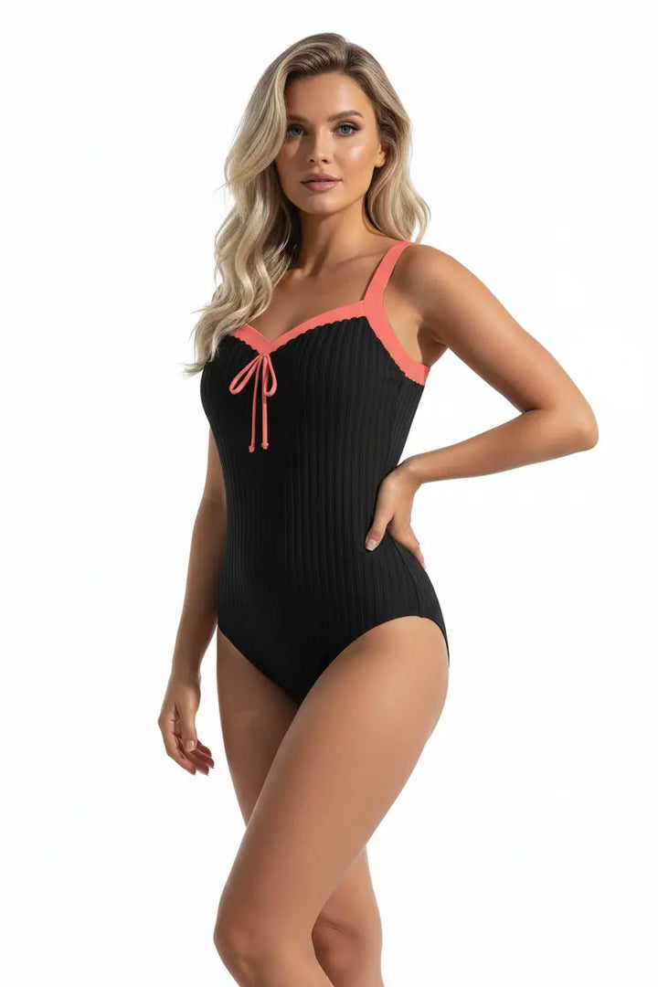 Women’s swimsuit with shorts sleeveless printed top beach setting natural light