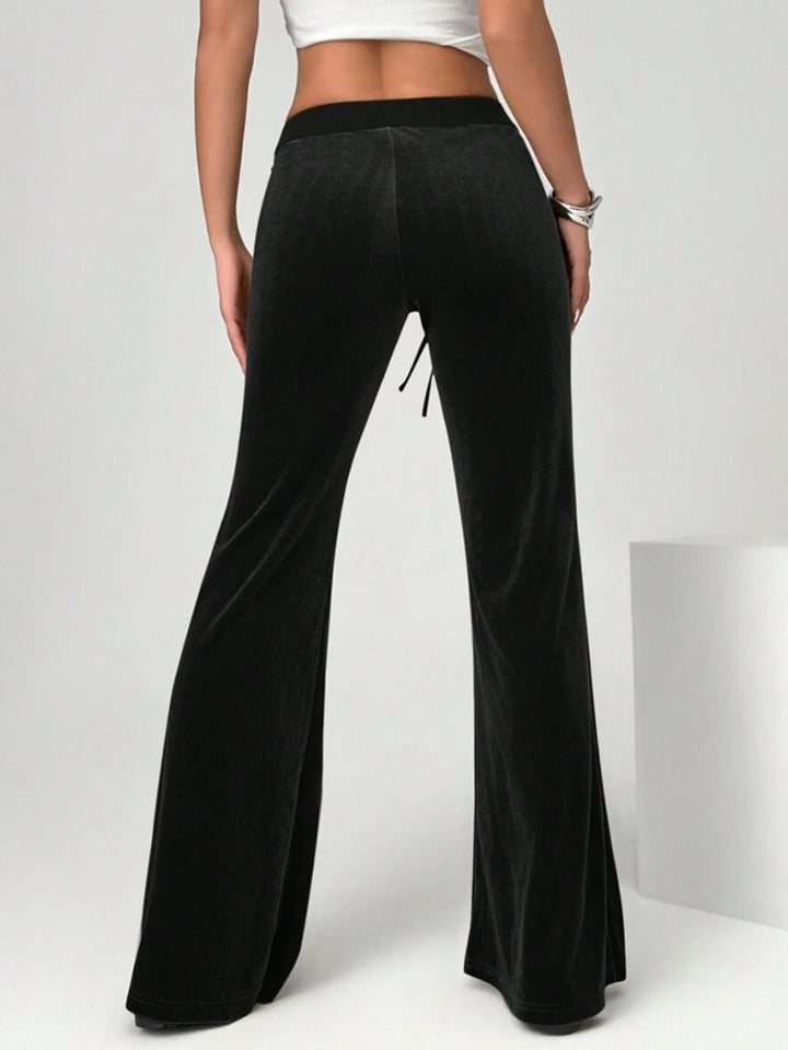 velvet flare pants waist tie close shot luxury texture emphasis