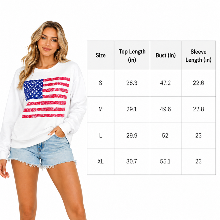 Woman wearing a white sweatshirt with an American flag design, standing next to a size chart.