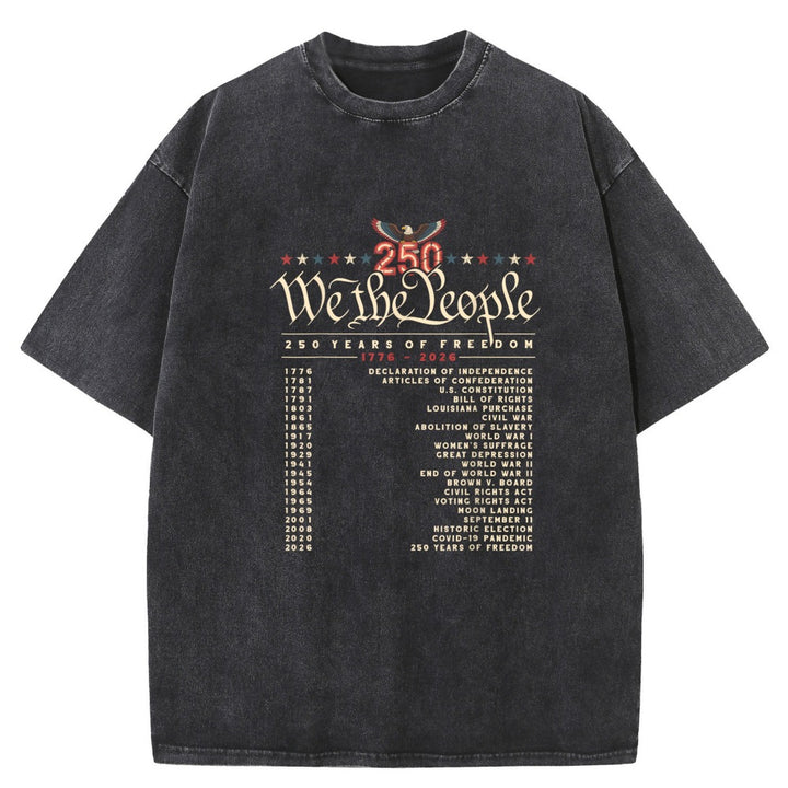 A washed black short-sleeve t-shirt featuring a distressed graphic on the front that reads &