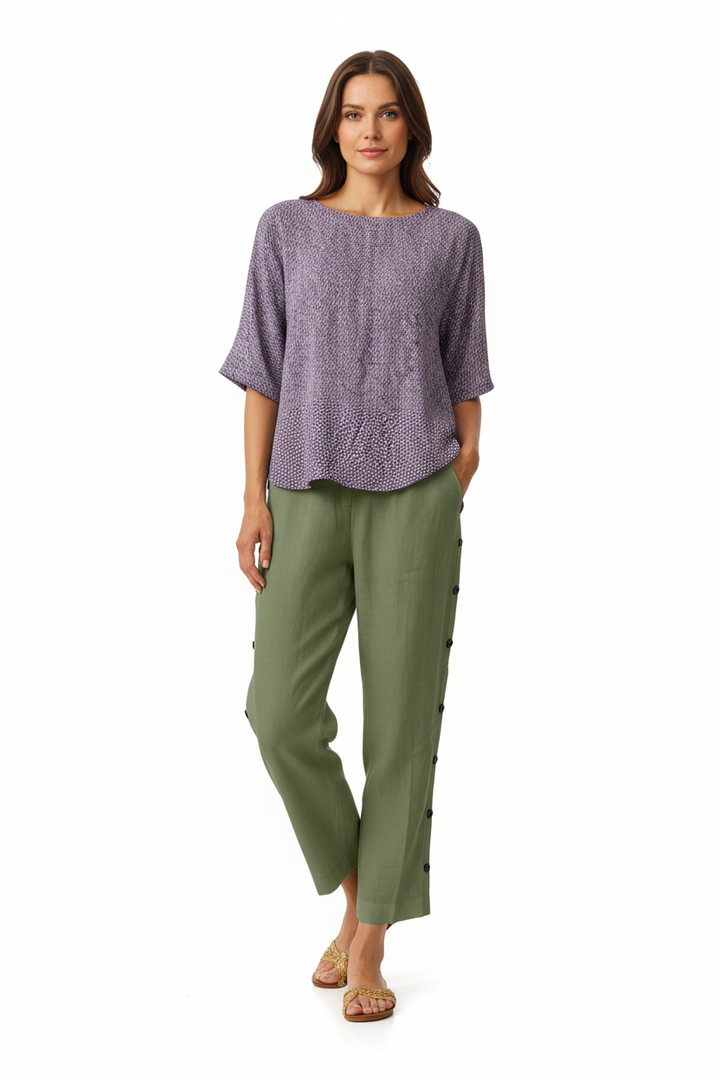 Full-length shot of black wide leg cropped pants with elastic waist and side button seam detail