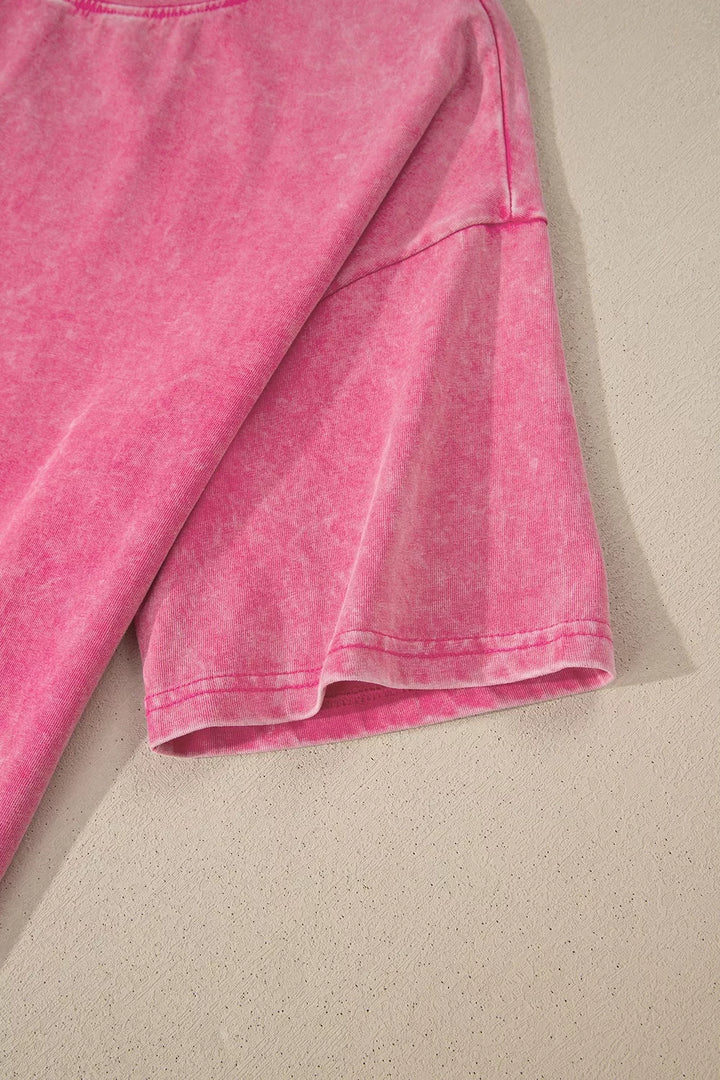 Close-up of a pink fabric item on a beige surface