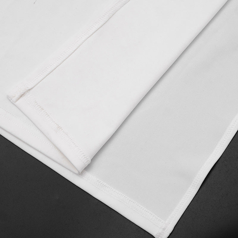 White maxi dress side view showing long silhouette, angled neckline, White color and patchwork detail in clean studio setting