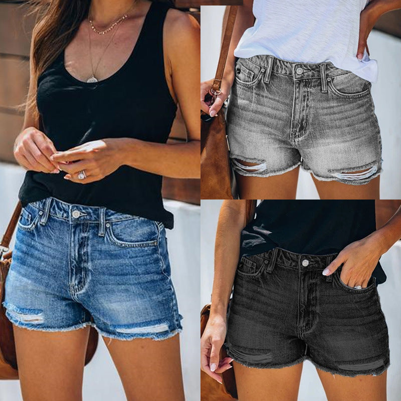 "fringe denim shorts folded product shot in grey with visible fringe trim, easy to pack for travel and summer weekends"
