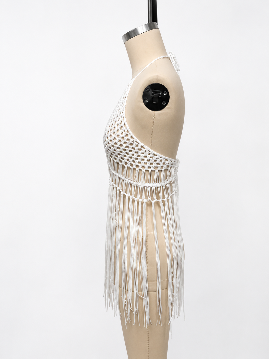 Hand crochet beach cover up with halter neckline, open knit pattern, and long tassel fringe for stylish summer layering