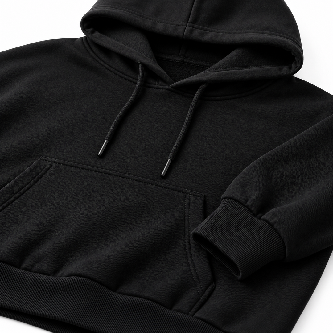 Black hoodie fabric and construction detail showing hood, cuff and pocket