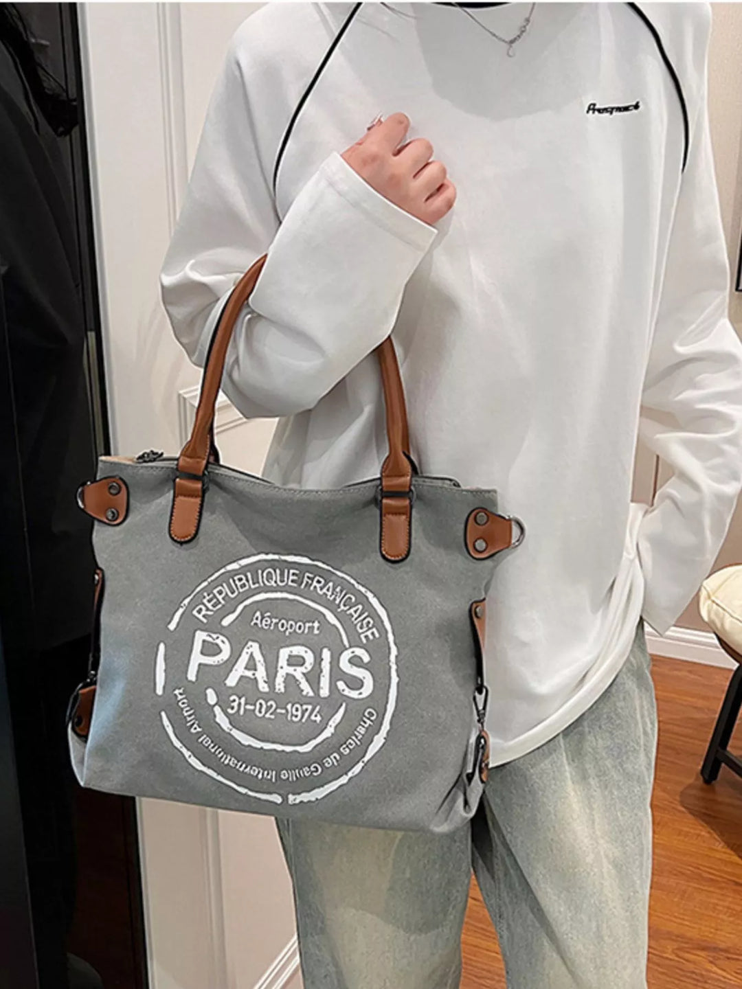 women's suede handbag carried by hand lifestyle context